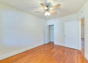 Thumbnail 11 of 16 - vacant bedroom with hardwood flooring, closet and ceiling fan at 4020 calvert street apartments in washington dc